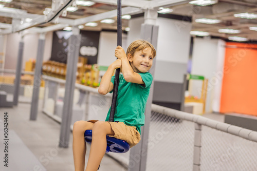 The boy has fun in an indoor playground