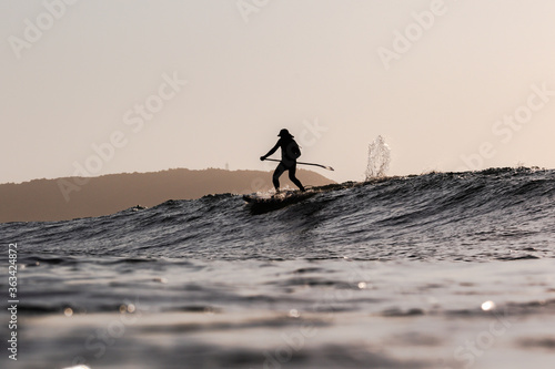 Surfing at sunrise & sunset in Japan Silhouettes of the Surfers taken while swimming in the Pacific Ocean.  photo