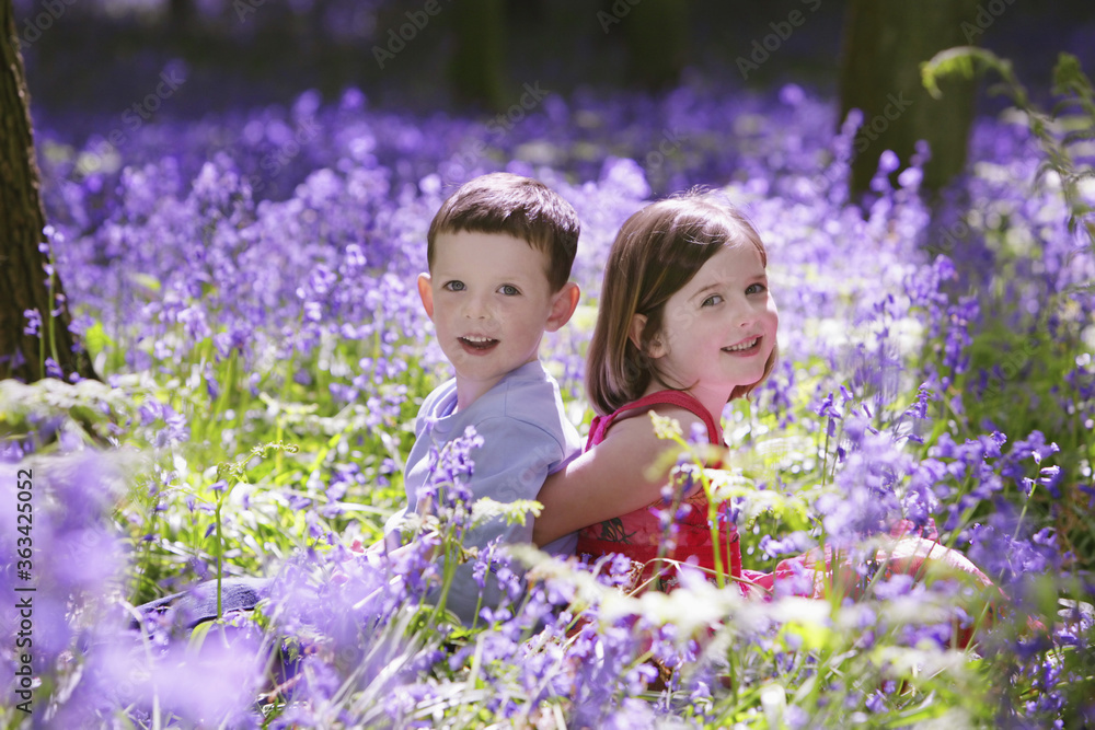 Boy and girl in field of flowers