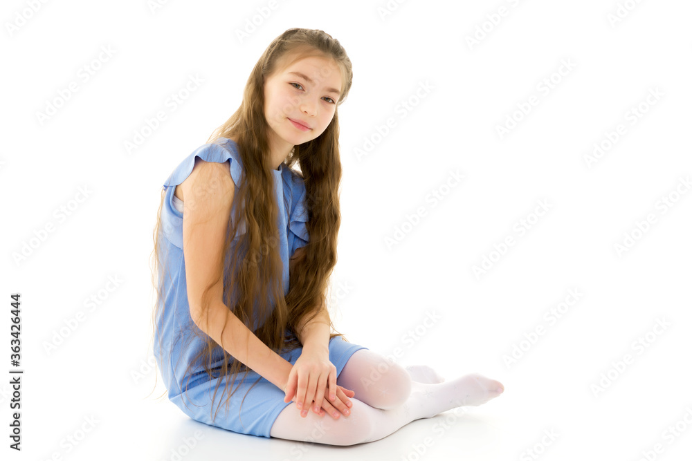 Little girl is sitting on the floor.The concept of a happy child Little girl is sitting on the floor.The concept of a happy child