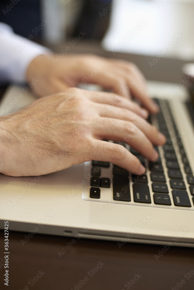 Hands typing on laptop Hands typing on laptop