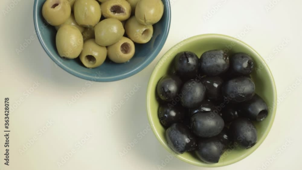 Green and black olives rotating medium flat lay shot Green and black olives rotating medium flat lay shot