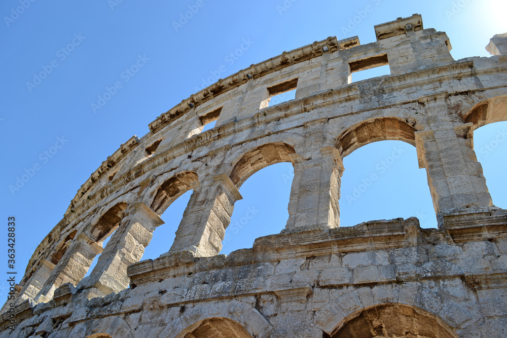 part of the amphitheater coliseum against the sky, arch-shaped opening