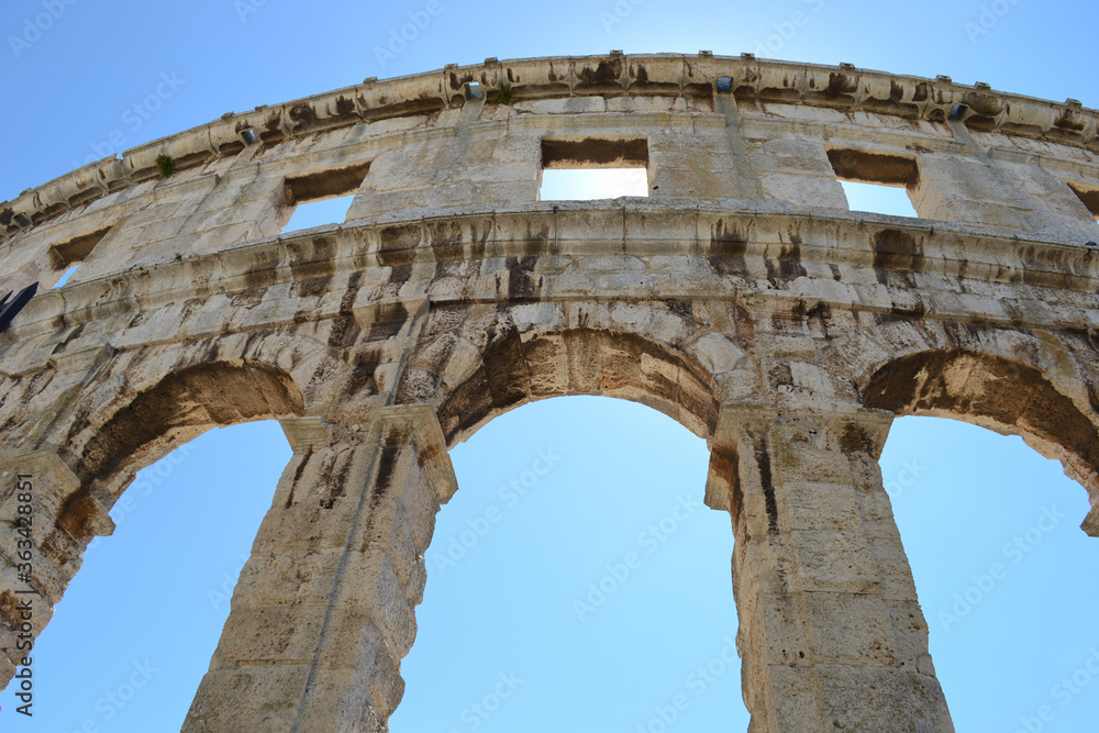 Roman amphitheatre in Pula Croatia. Part of the amphitheater against the sky, arch-shaped opening.