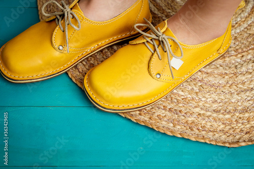 Ladies yellow mustard leather shoes isolated close-up photo