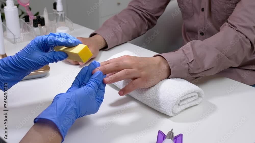 Manicure master working with male client in beauty salon, closeup Manicure master working with male client in beauty salon, closeup
