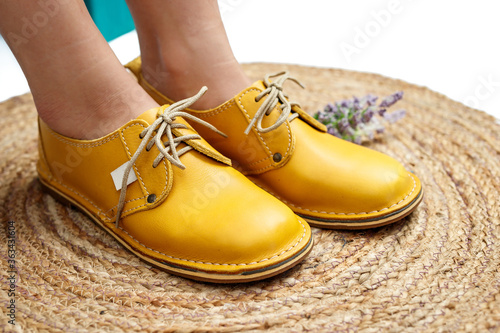 Ladies yellow mustard leather shoes isolated close-up