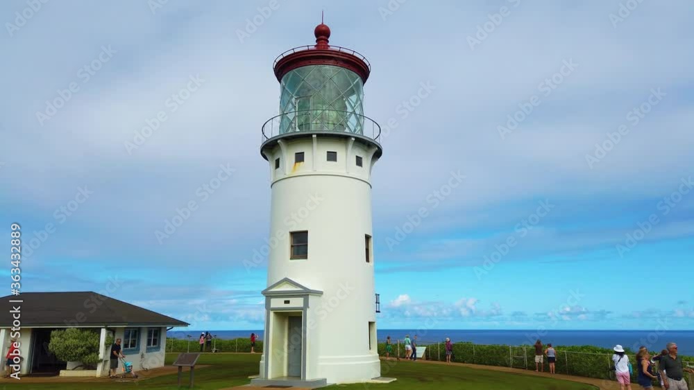 4K Hawaii Kauai wide shot of Kilauea Point Lighthouse trucking in and straight under to tight shot looking up and passing by lighthouse with partly cloudy sky 4K Hawaii Kauai wide shot of Kilauea Point Lighthouse trucking in and straight under to tight shot looking up and passing by lighthouse with partly cloudy sky
