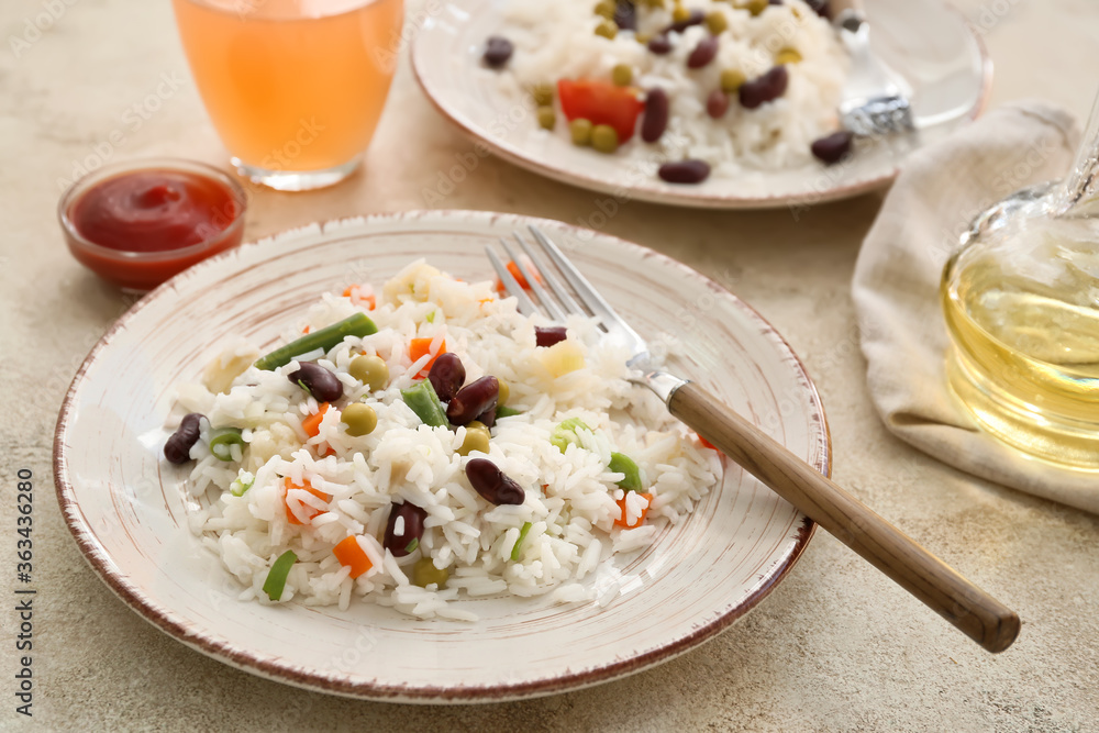 Plate with tasty rice, beans and vegetables on table Plate with tasty rice, beans and vegetables on table