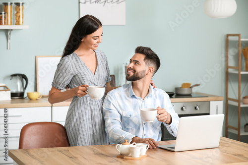 Happy young couple drinking...