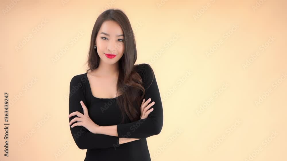 A beautiful woman's reaction to what's being said to her goes from annoyed to smiling and happy. A beautiful woman's reaction to what's being said to her goes from annoyed to smiling and happy.