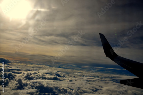 Kunming, China - July 21, 2019: view of an aeroplane wing above the clouds during sunset. The flight was Dhaka to Kunming by China Eastern airlines.
