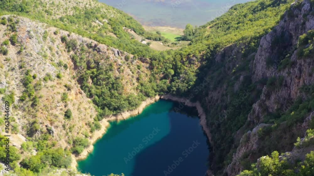 Blue Lake Galjipovac in the Prolosko Blato area of Croatia leading to marshes ahead, Aerial flyover view Blue Lake Galjipovac in the Prolosko Blato area of Croatia leading to marshes ahead, Aerial flyover view