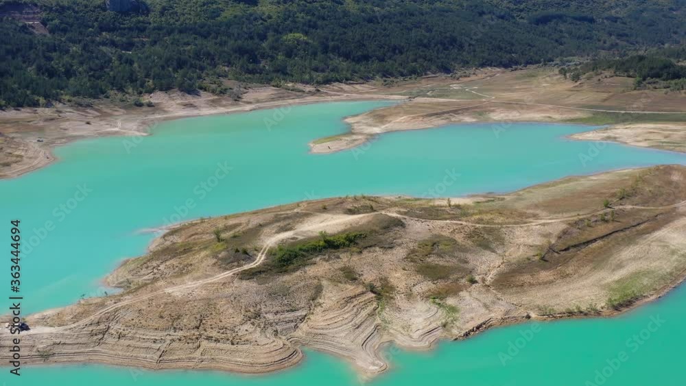Rocky peninsula formation on Zeleno jezero reservoir lake in Croatia with low water level, Aerial dolly in shot Rocky peninsula formation on Zeleno jezero reservoir lake in Croatia with low water level, Aerial dolly in shot