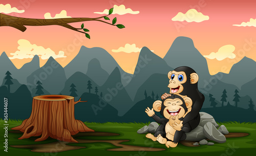 A chimpanzee with her cub in a bare forest