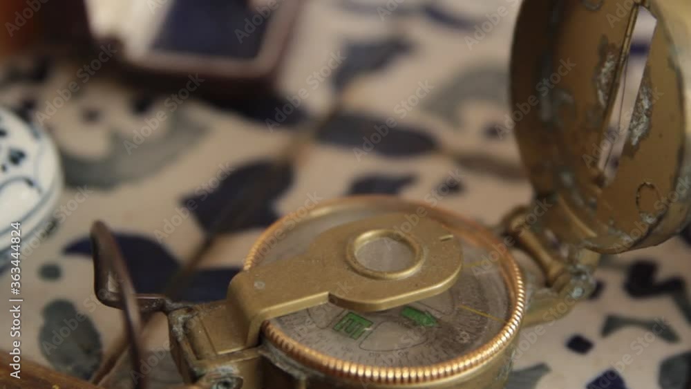 Old magnetic compass close up with a pan movement in antique living room Old magnetic compass close up with a pan movement in antique living room