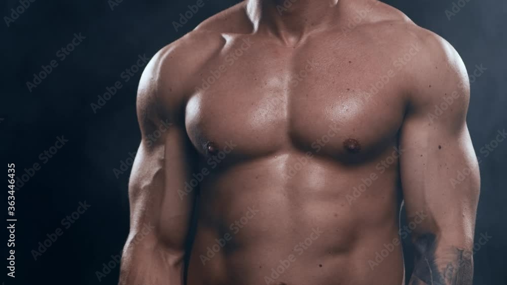 Fit and sporty bodybuilder over black background. Bodybuilder in studio. Sport and fitness. Fit and sporty bodybuilder over black background. Bodybuilder in studio. Sport and fitness.