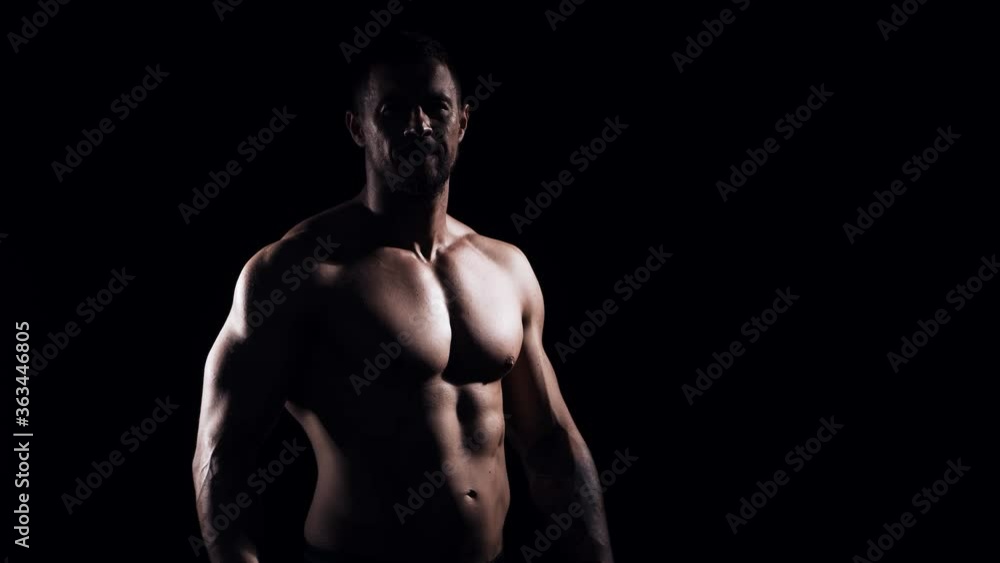 Fit and sporty bodybuilder over black background. Bodybuilder in studio. Sport and fitness. Fit and sporty bodybuilder over black background. Bodybuilder in studio. Sport and fitness.