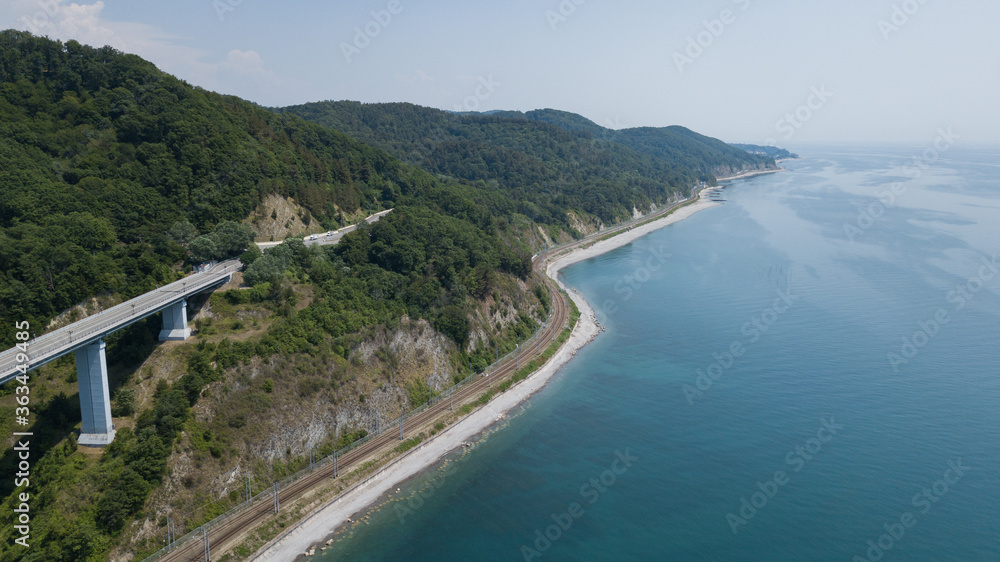 Aerial view of high bridge and mountain road with cars and truck, Black Sea, Russia