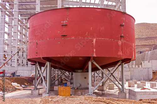 View of the flotation chemical tank (thickener tank) for the mineral separation in the mine plant. Froth flotation is a process for selectively separating hydrophobic materials from hydrophilic. photo