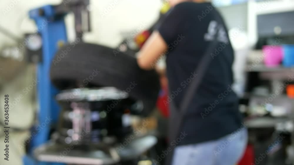 abstract blurred of mechanic worker makes computer wheel balancing machine at garage. abstract blurred of mechanic worker makes computer wheel balancing machine at garage.