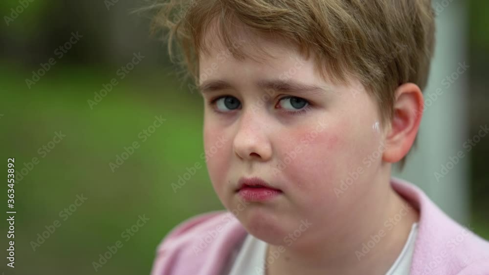 portrait of a plump sad girl with short blond hair on a green lawn portrait of a plump sad girl with short blond hair on a green lawn