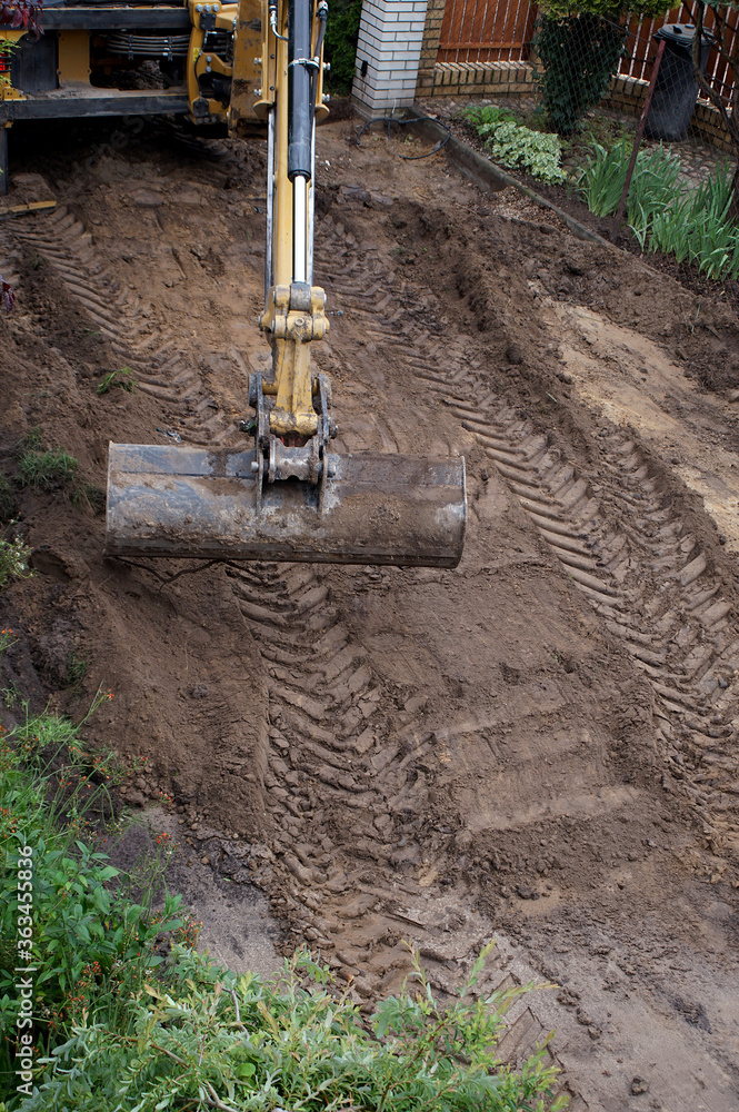 leveling the ground by an excavator on the construction site leveling the ground by an excavator on the construction site
