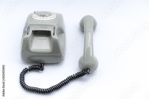 Old disk telephone on a white background