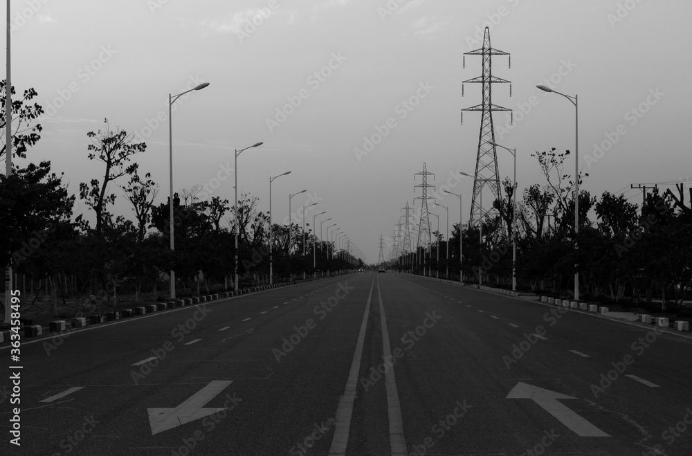 Asphalt road and high voltage power towers