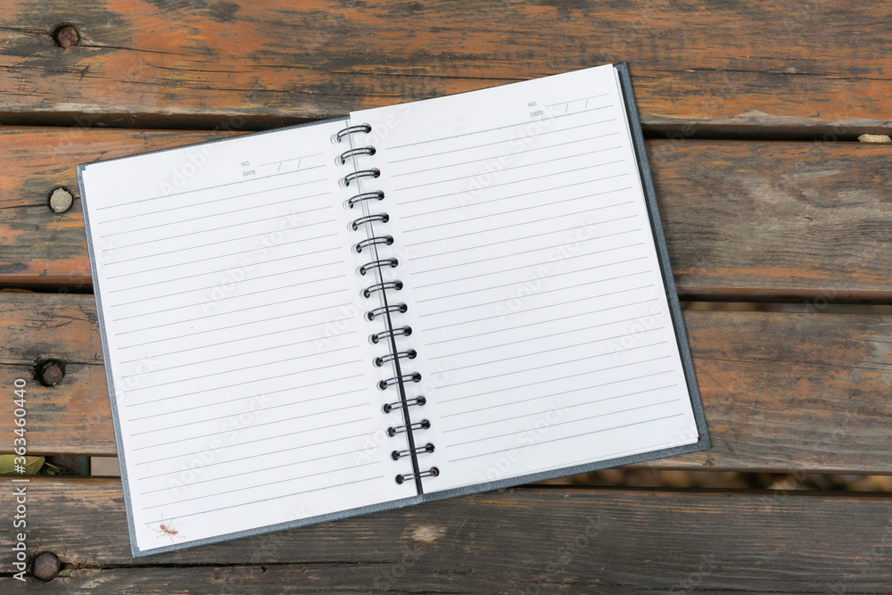 Open Notebook on wooden table on natural background Open Notebook on wooden table on natural background