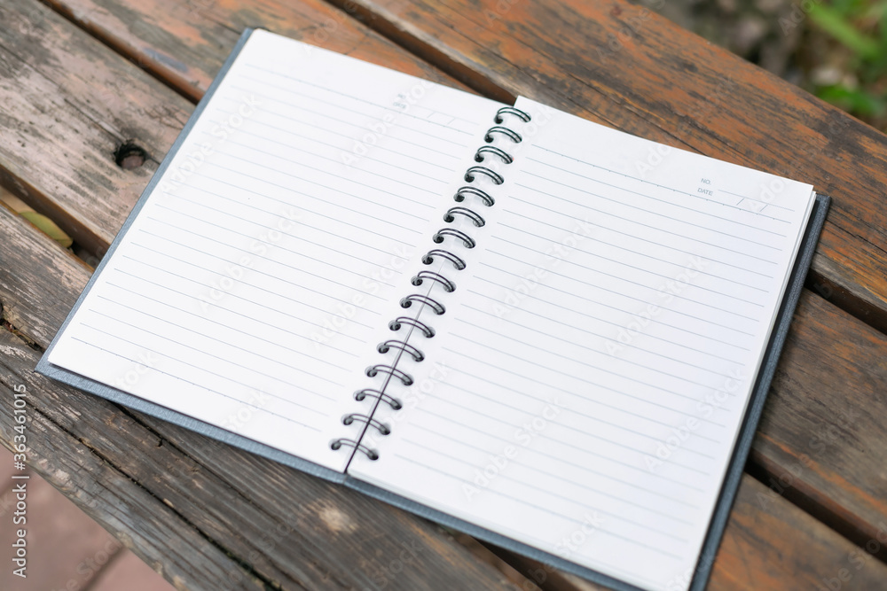 Open Notebook on wooden table on natural background Open Notebook on wooden table on natural background