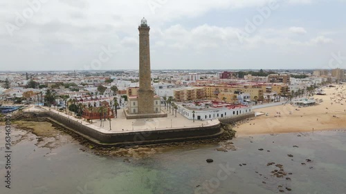 Aerial view. The highest lighthouse on the coast is that of Chipiona on the Atlantic in Andalusia. The drone flies a quarter circle to the left and shows the city and the southern coast.