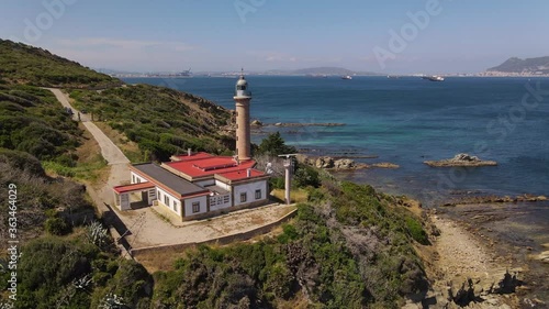 Aerial view from the Carnero lighthouse on the Strait of Gibraltar. The Bay of Algaciras and the British Rock of Gibraltar can be seen in the background. Many ships are in the bay.