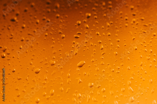 Raindrops on window glass,condensation on the window,natural background,color texture,orange abstract and pattern 