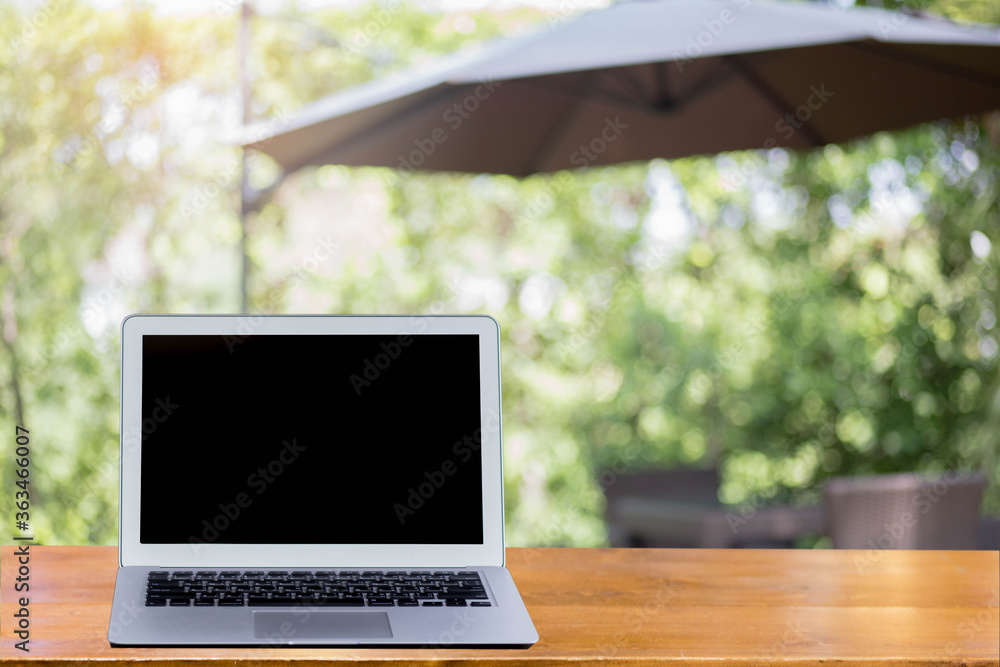 Outdoor office desk with laptop in the garden.Computer Laptop and tablet computer on the table blur background with bokeh, business technology concept ,Outdoor office desk with laptop in the garden. Outdoor office desk with laptop in the garden.Computer Laptop and tablet computer on the table blur background with bokeh, business technology concept ,Outdoor office desk with laptop in the garden.