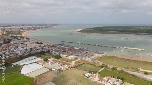 Aerial view with the drone on the Atlantic estuary of the Guadalquivir river in Andalusia. The drone flies to the mouth and stops above the ships.