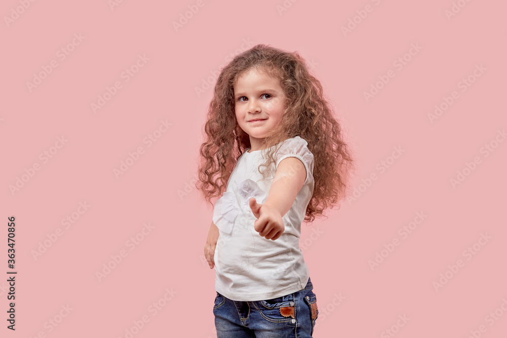 Happy cheerful girl with curly loose white hair showing thumbs up gesture. Happy cheerful girl with curly loose white hair showing thumbs up gesture.