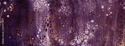 Very beautiful texture background. Purple paint flows in gold with the addition of white paint. Style includes curls of marble or agate with bubbles and cells. Natural style.
