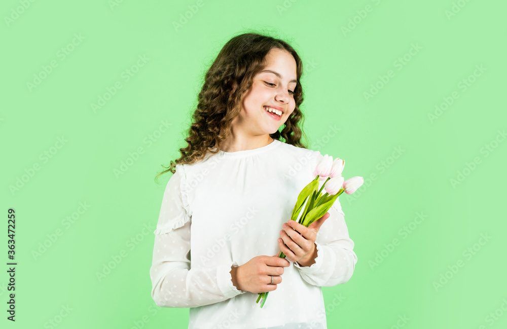 happy girl hold tulip flowers. spring bouquet. happy womens day. international childrens day. mothers day concept. cheerful little girl with curly hair. tulips flowers for child happy girl hold tulip flowers. spring bouquet. happy womens day. international childrens day. mothers day concept. cheerful little girl with curly hair. tulips flowers for child
