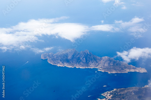 Dragonera Islands airplane view with clouds. Blue sky and clouds over the mediterranean. Balearic Island's Dragonera National Park. 