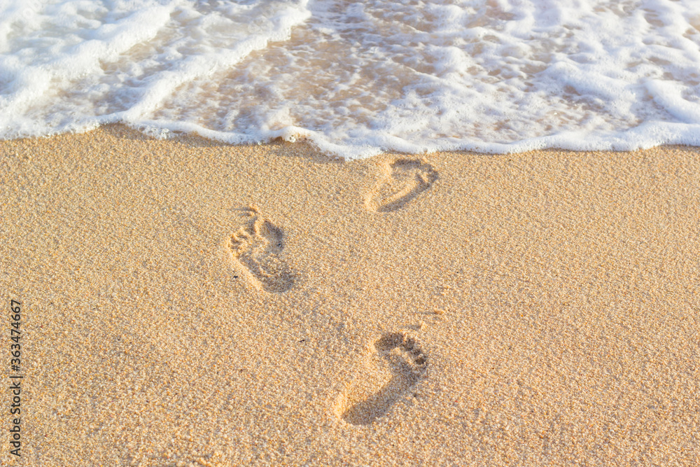 footprints of people stepping on the sand in the sea footprints of people stepping on the sand in the sea