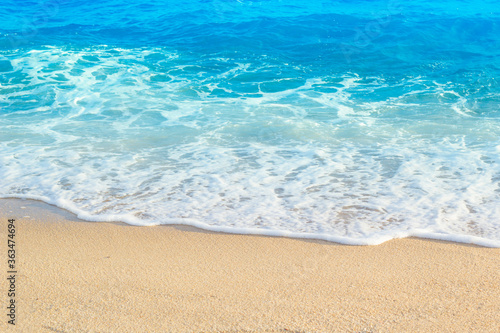 wave of blue ocean on sandy beach. Background.