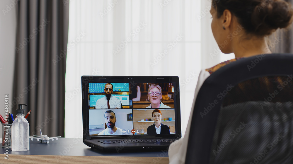 Female freelancer in a video conference with business partners. Female freelancer in a video conference with business partners.