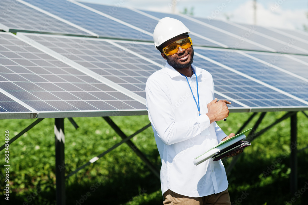 African american technician check the maintenance of the solar panels. Black man engineer at solar station.