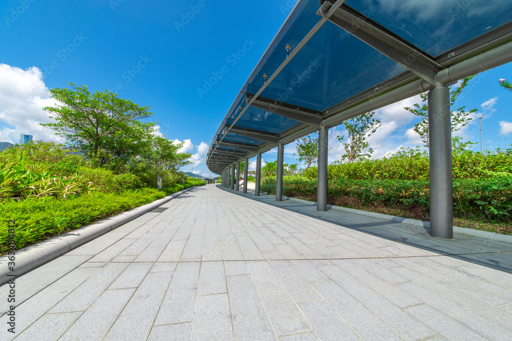 Glass shade corridors in modern parks under the blue sky and white clouds. Glass shade corridors in modern parks under the blue sky and white clouds.