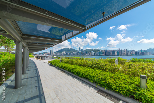 Glass shade corridors in modern parks under the blue sky and white clouds.