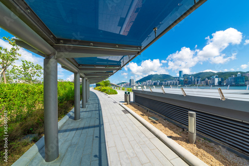 Glass shade corridors in modern parks under the blue sky and white clouds.