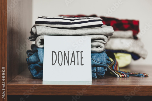 Fotografija Stack of old clothes to discard (declutter) or donate