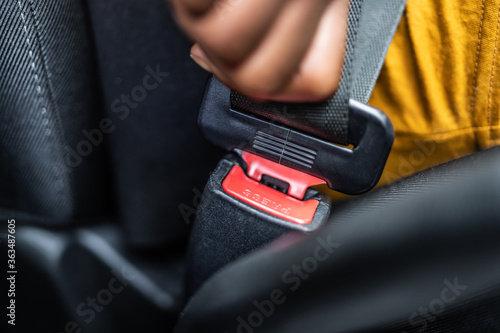 African Woman Buckling Up Seatbelt photo