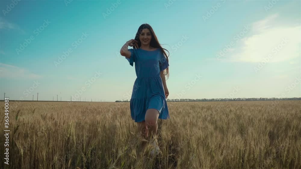 Young woman runs across field. Beautiful free girl enjoying nature in warm sunshine in wheat on sunset background. Happy and successful lifestyle concept Young woman runs across field. Beautiful free girl enjoying nature in warm sunshine in wheat on sunset background. Happy and successful lifestyle concept
